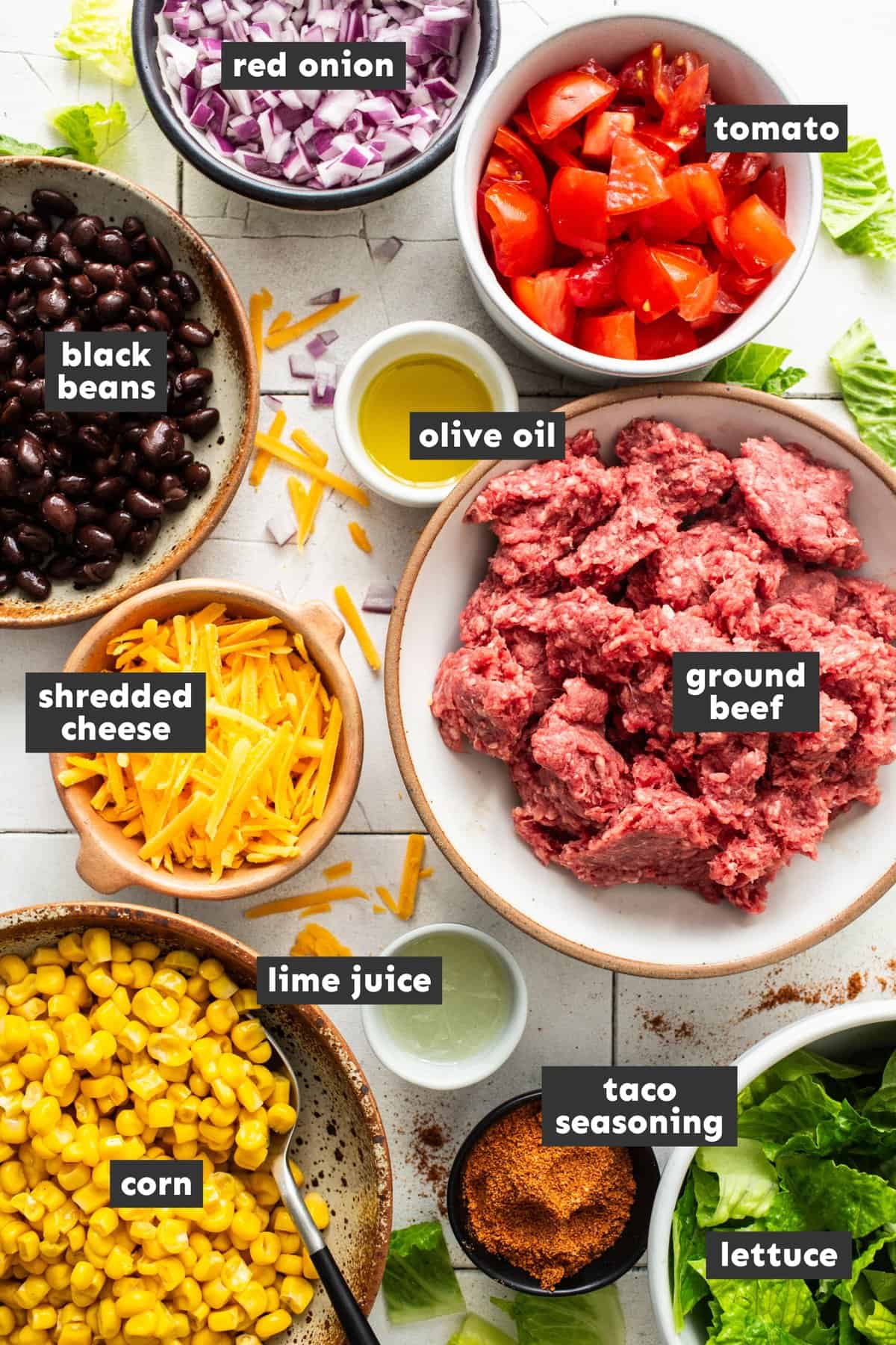 Taco salad ingredients on a table.