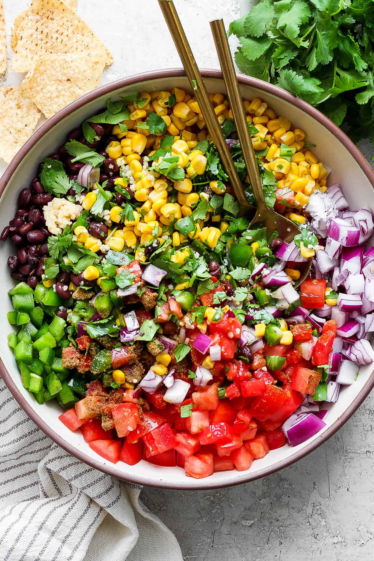 Black bean and corn salsa in a bowl with a serving spoon.