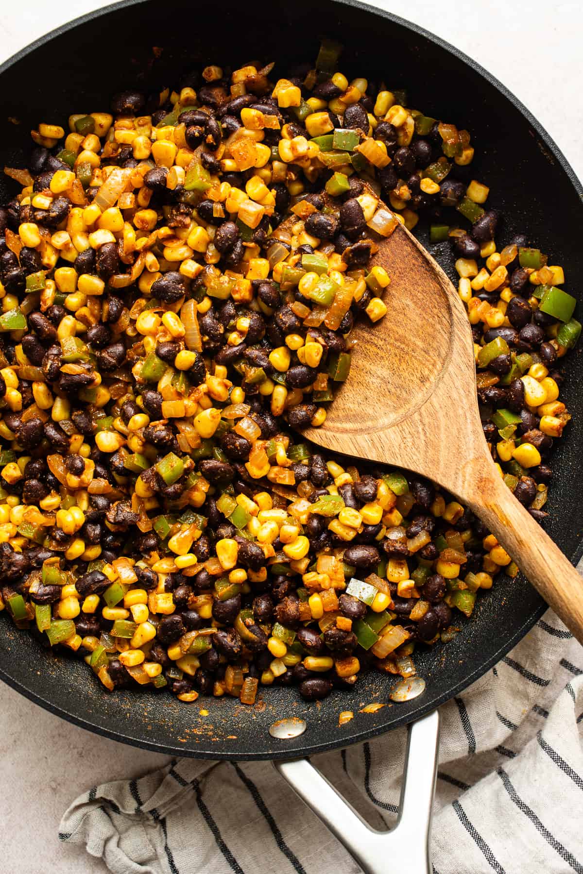 Black bean and corn filling for quesadillas in a skillet.