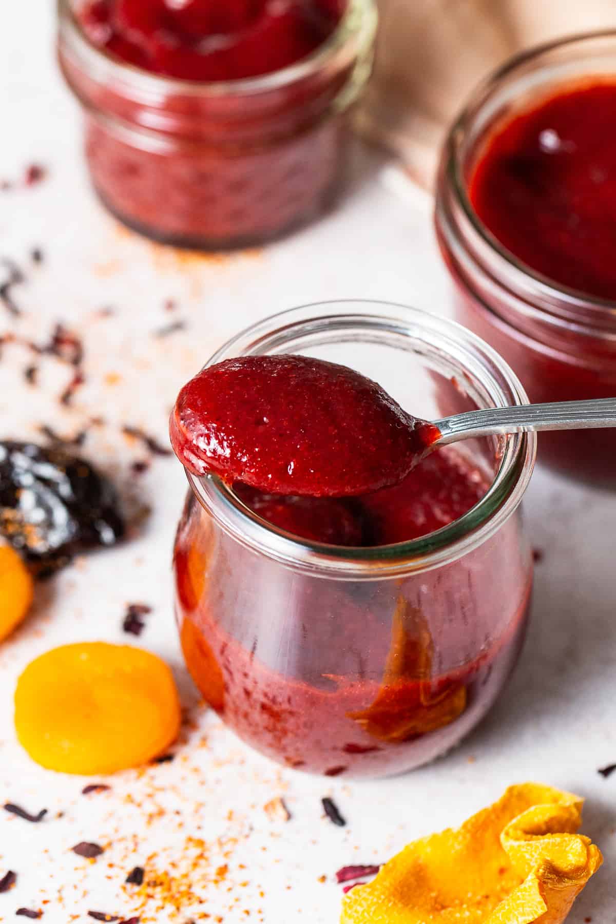 Homemade chamoy on a spoon in a jar.