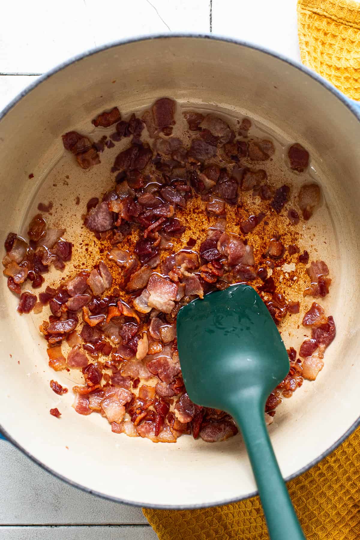 Chopped bacon cooking in a pot for charro beans.