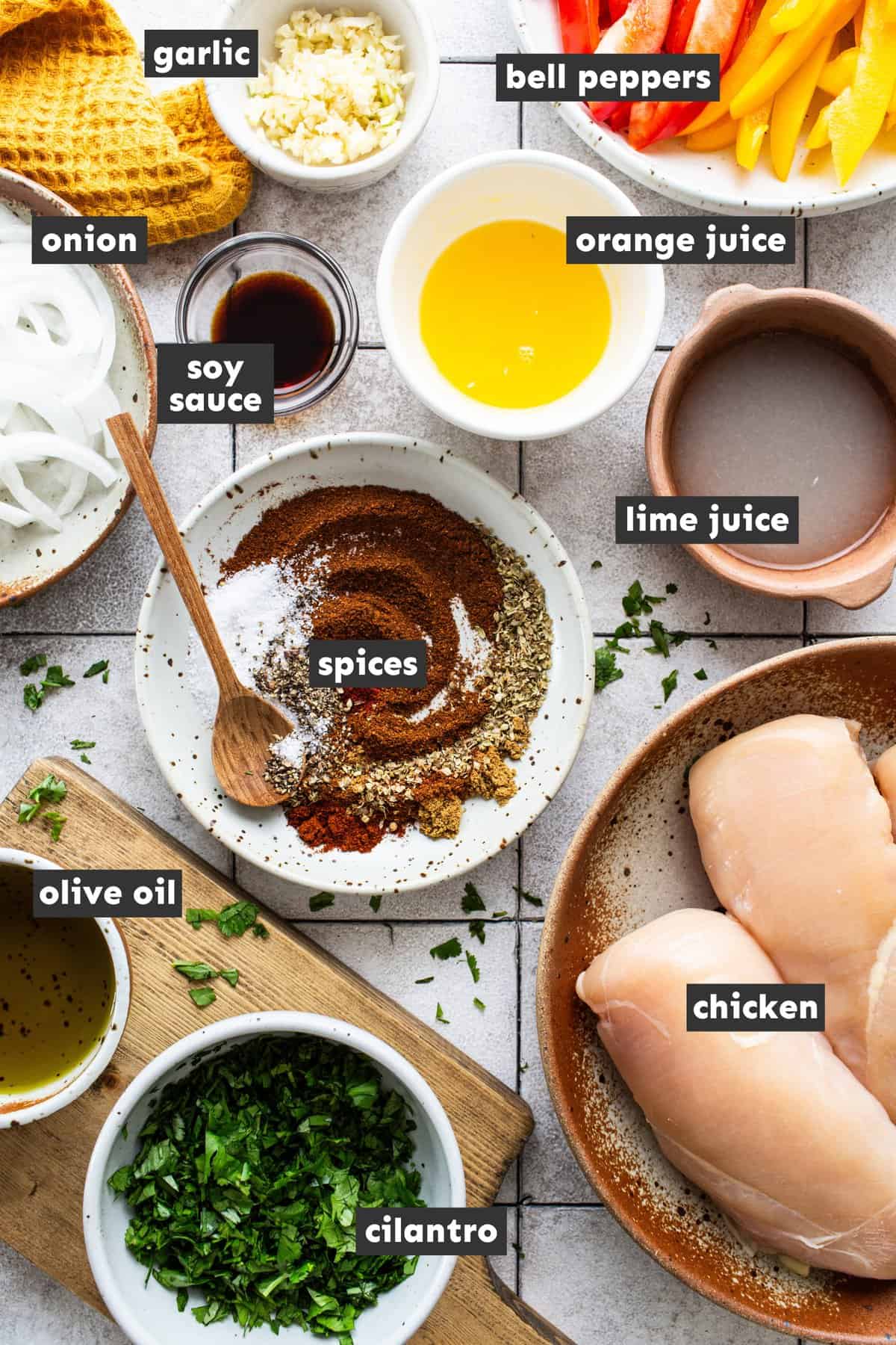 Chicken fajita ingredients in various sized bowls.