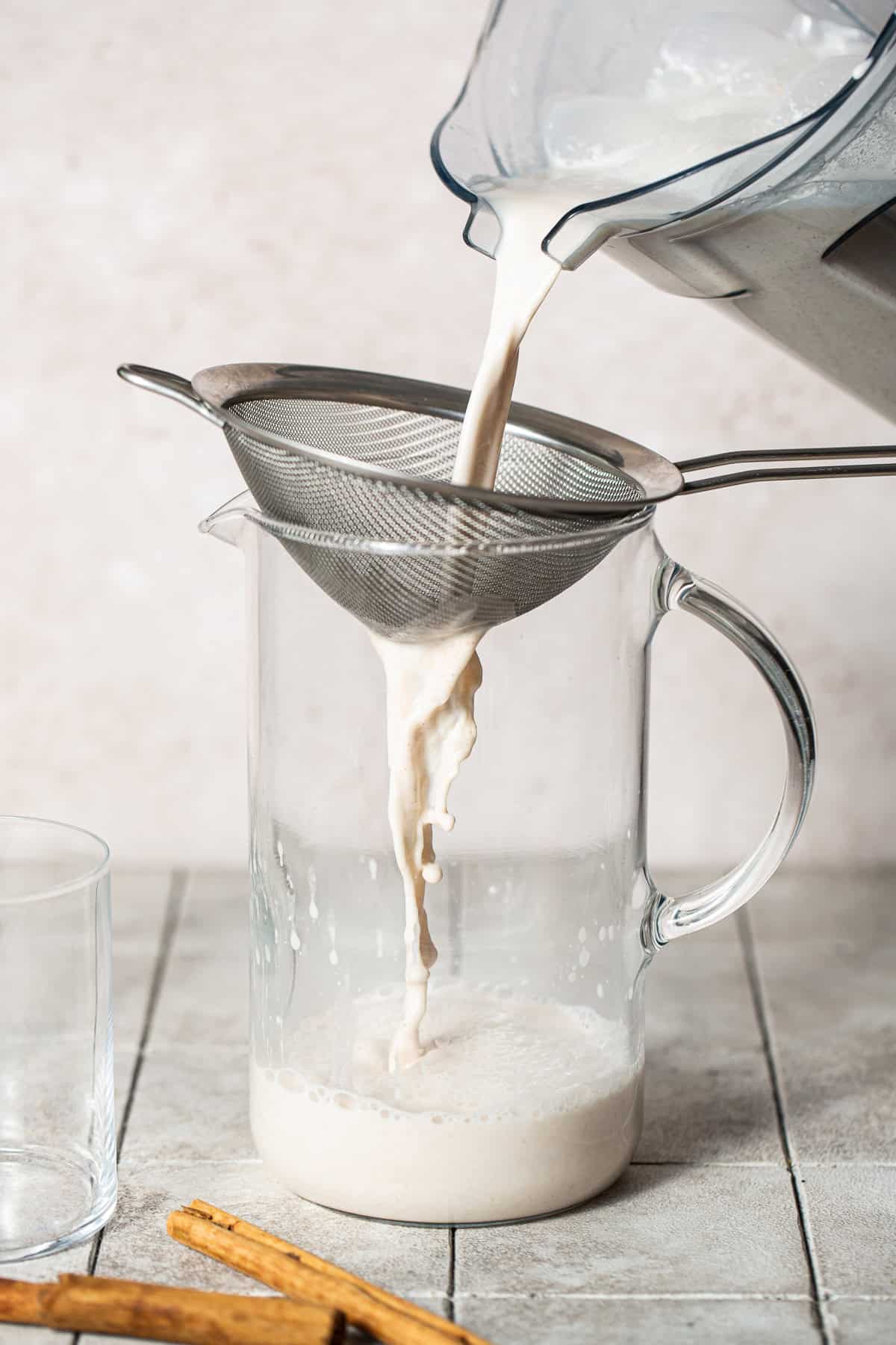Straining blended mixture through a strainer