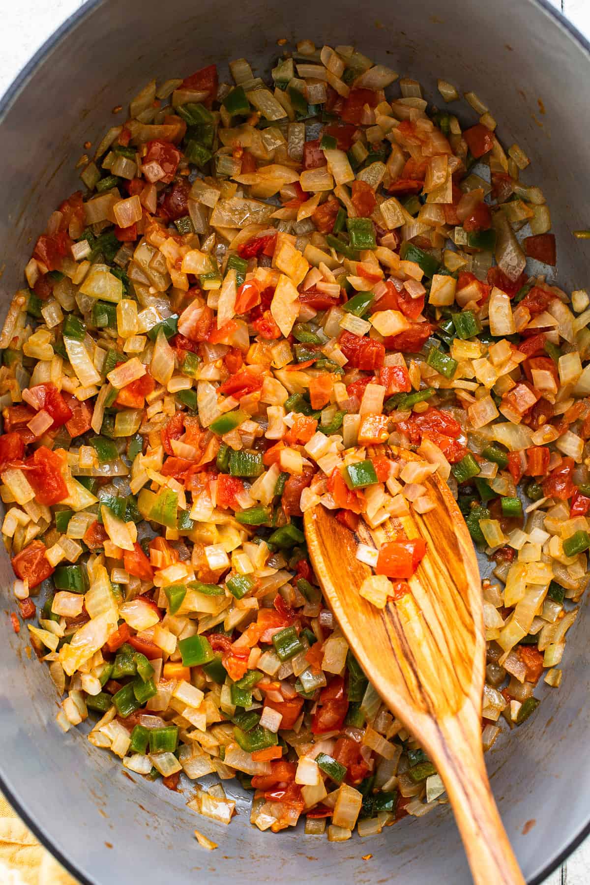 Sauteed vegetables in a large pot.