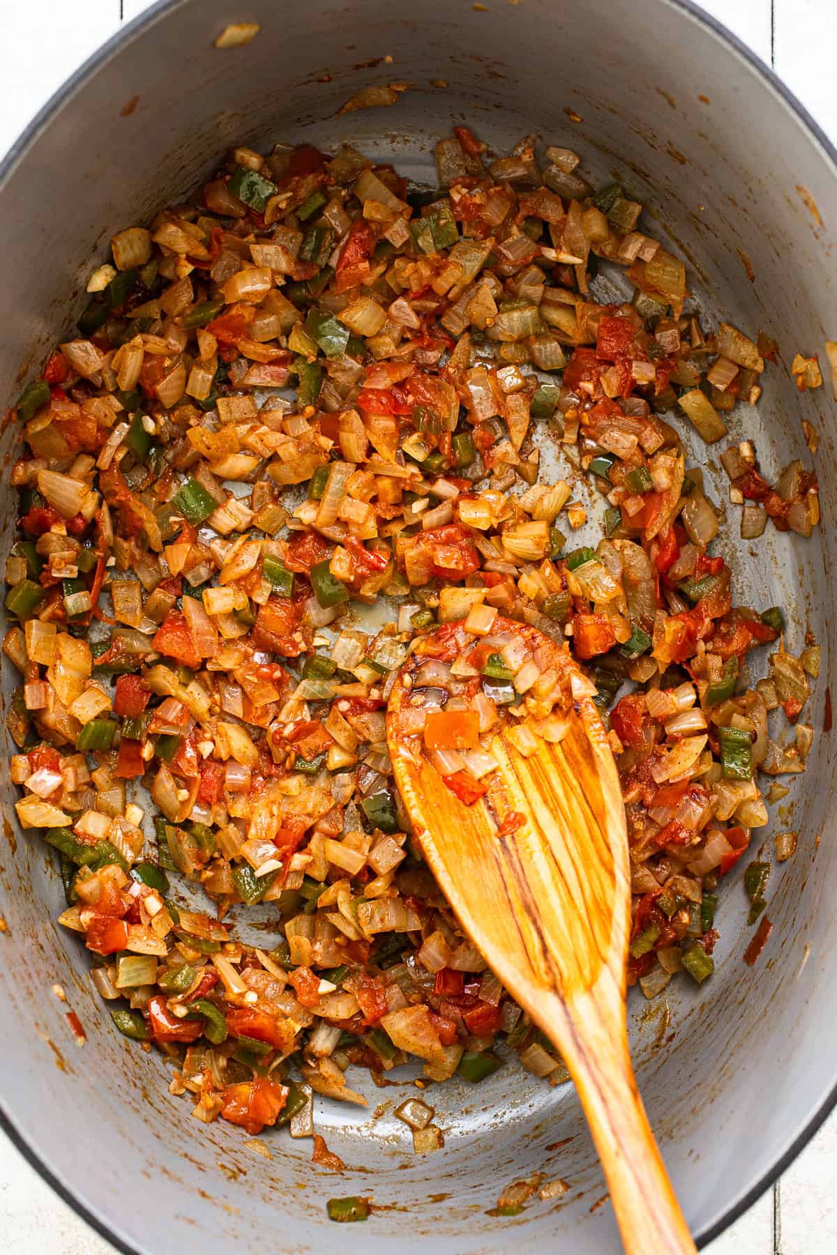 Adding in all seasonings to the pit of sautéed vegetables. 