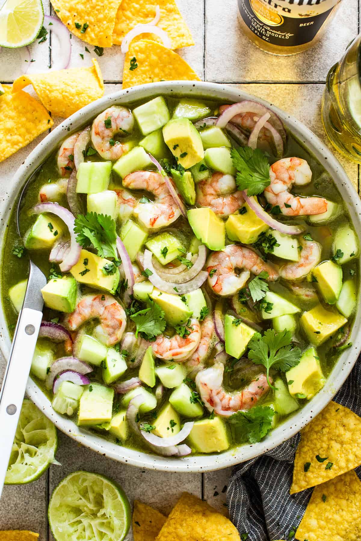 Aguachile in a bowl with tortilla chips on the side.