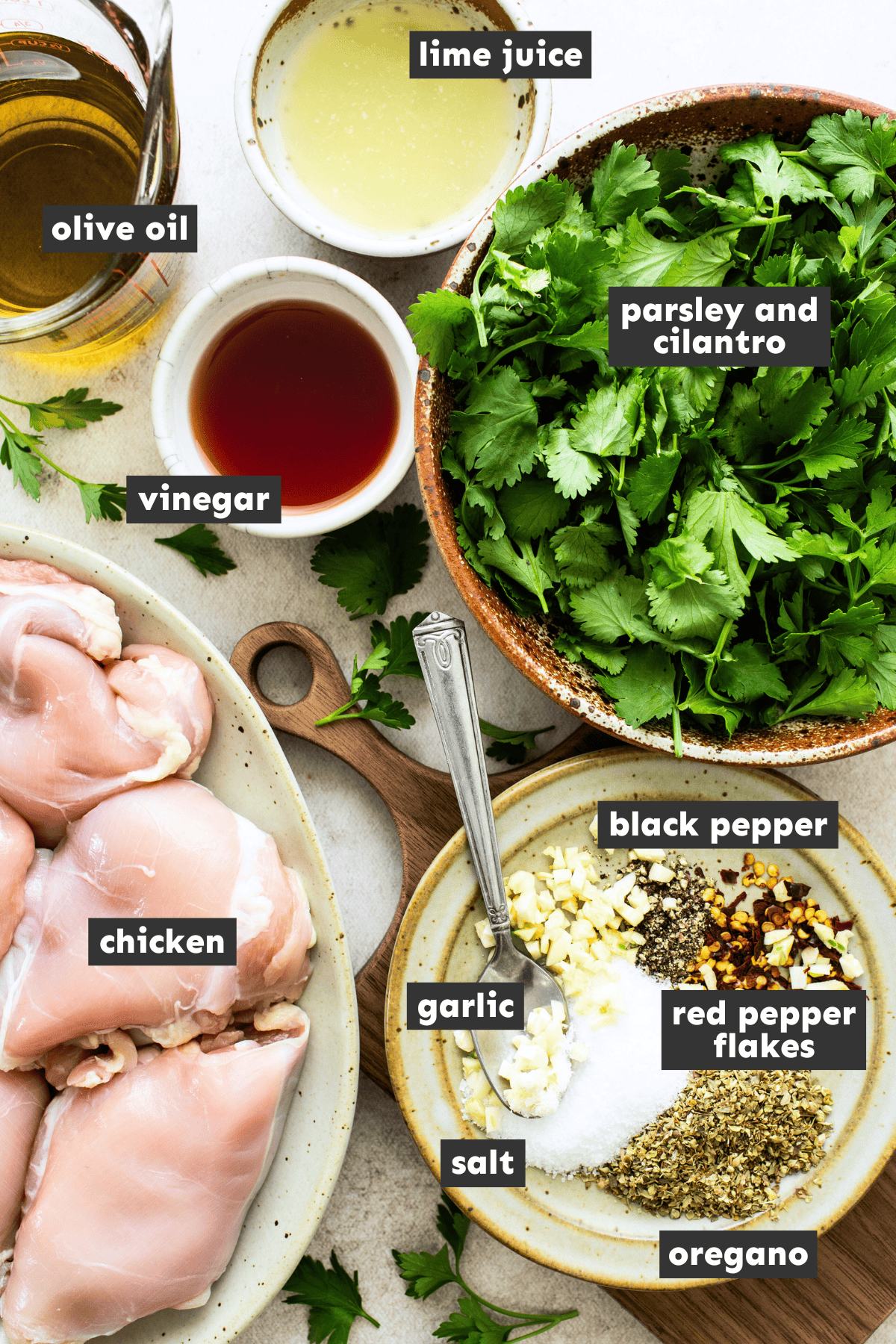Chimichurri chicken ingredients separated into mixing bowls 