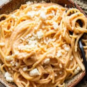 Espagueti Rojo in a bowl garnished with crumbled cotija cheese.