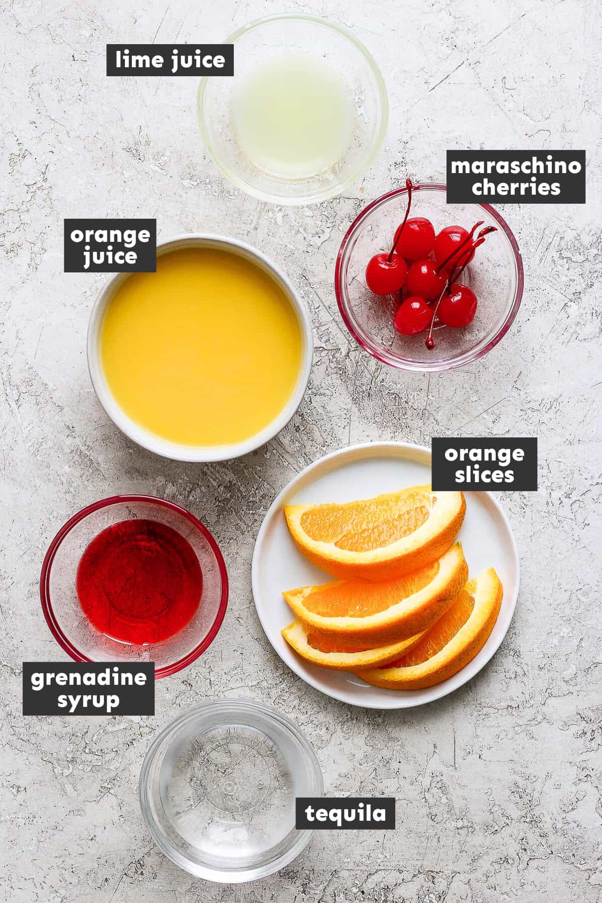 Ingredients for tequila sunrise on a table.