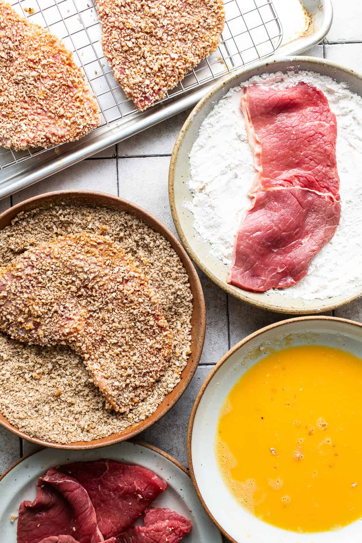 Torta de Milanesa in a bowl being breaded