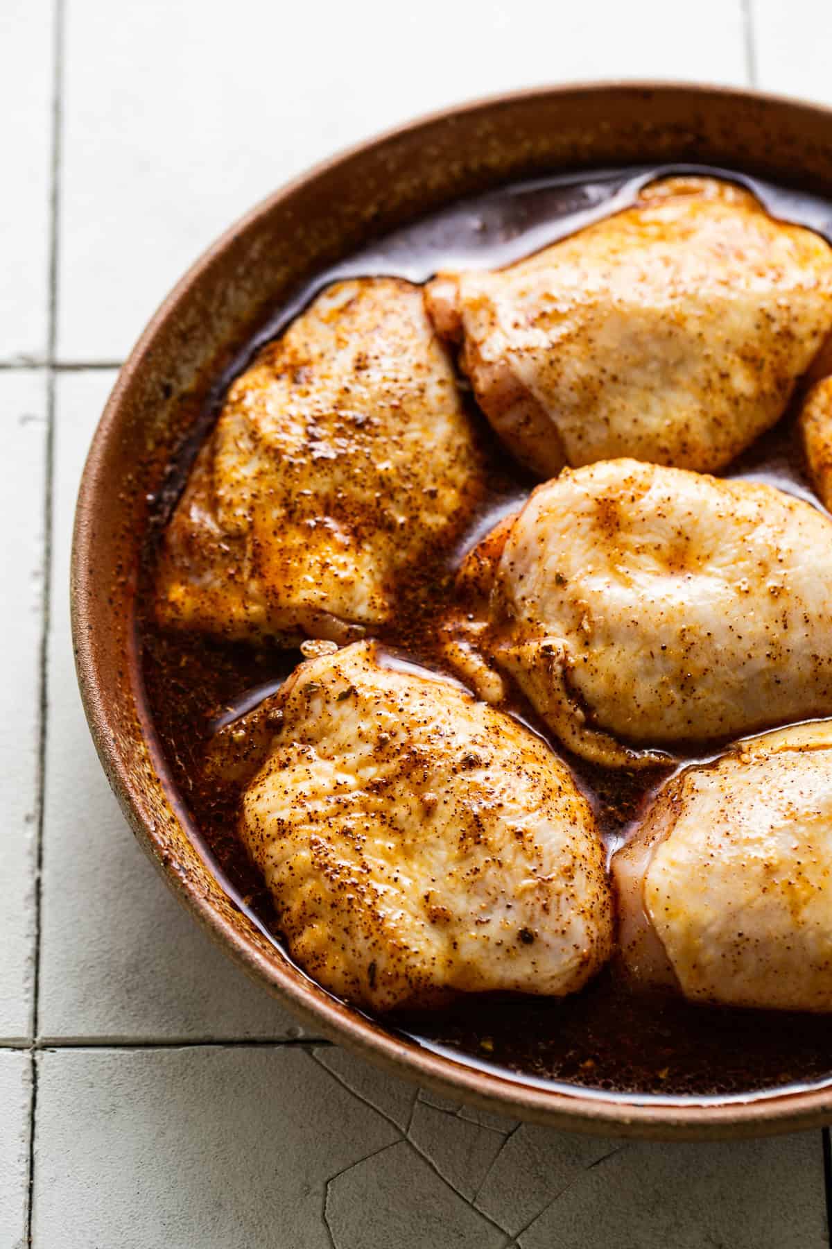 Raw chicken soaked in seasonings to be marinated