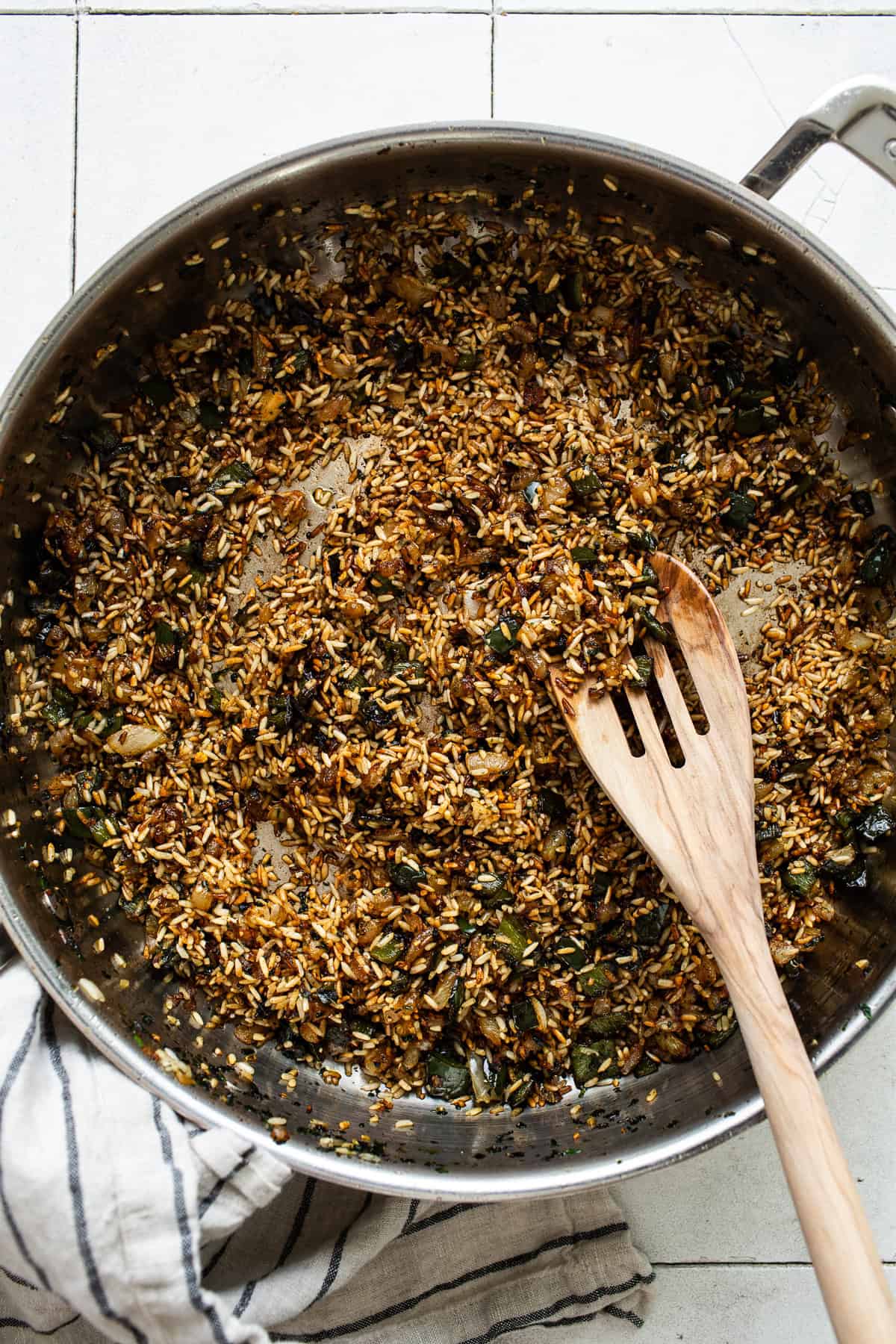 Browning the rice until light brown colored