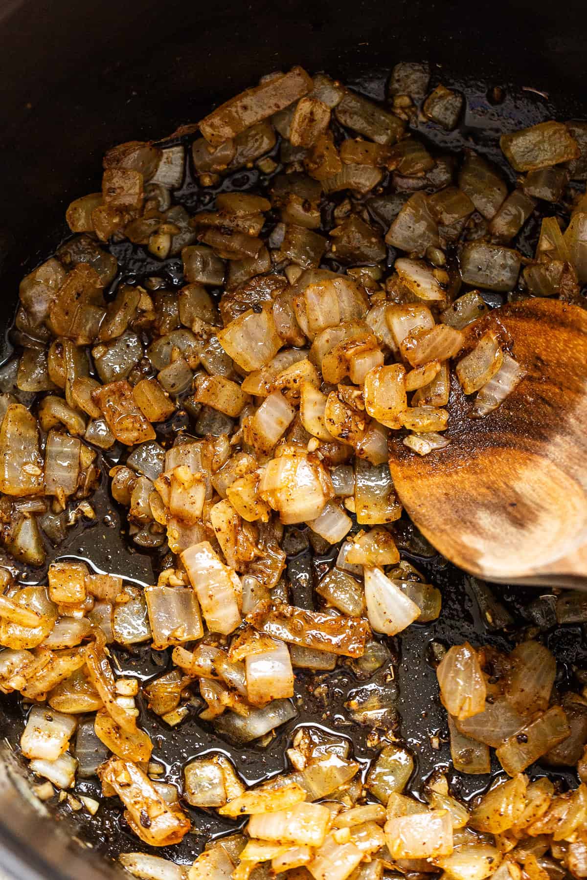 Sautéed onions and seasonings in a pot.