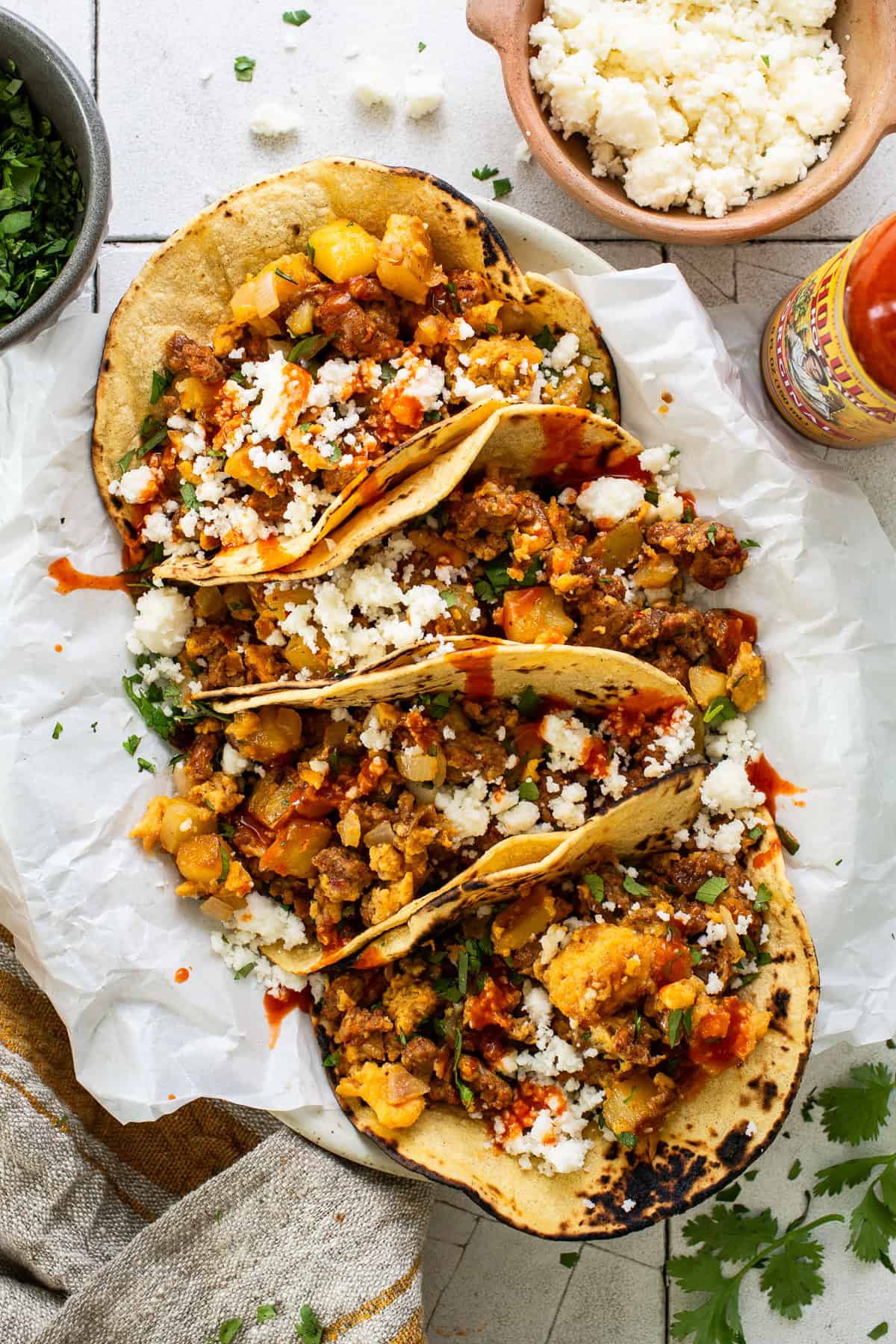 Breakfast Tacos on a plate with chorizo, potatoes, and eggs.
