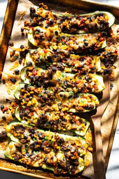 Stuffed zucchini boats filled with black beans, corn, cheese, and salsa.