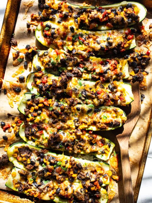 Stuffed zucchini boats filled with black beans, corn, cheese, and salsa.