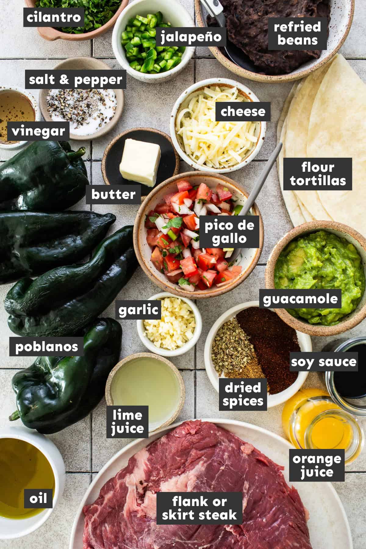 Ingredients for carne asada burritos laid out on a table ready to use.
