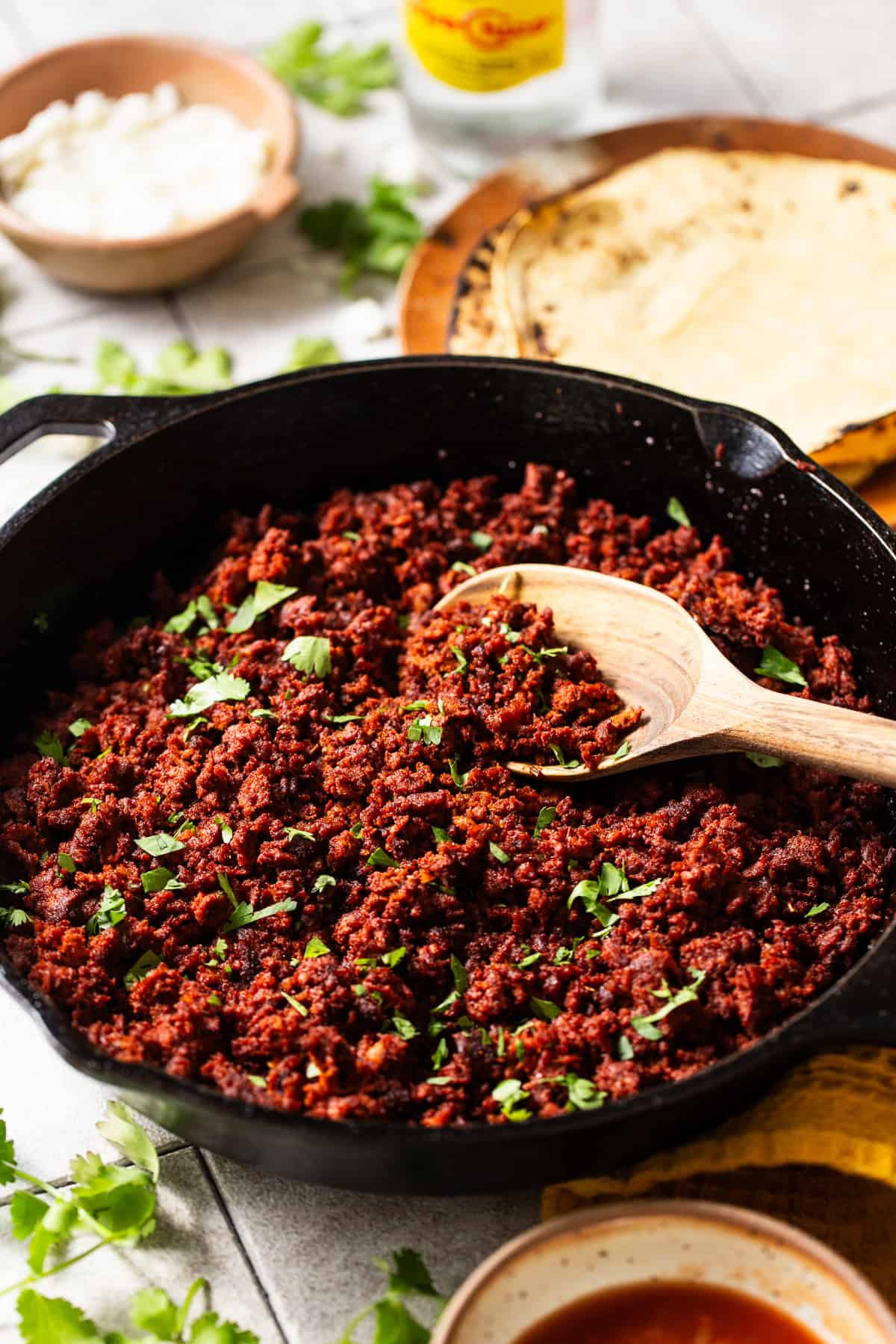 Seasoned Mexican chorizo in a skillet garnished with cilantro ready to eat in tacos, eggs, and more.