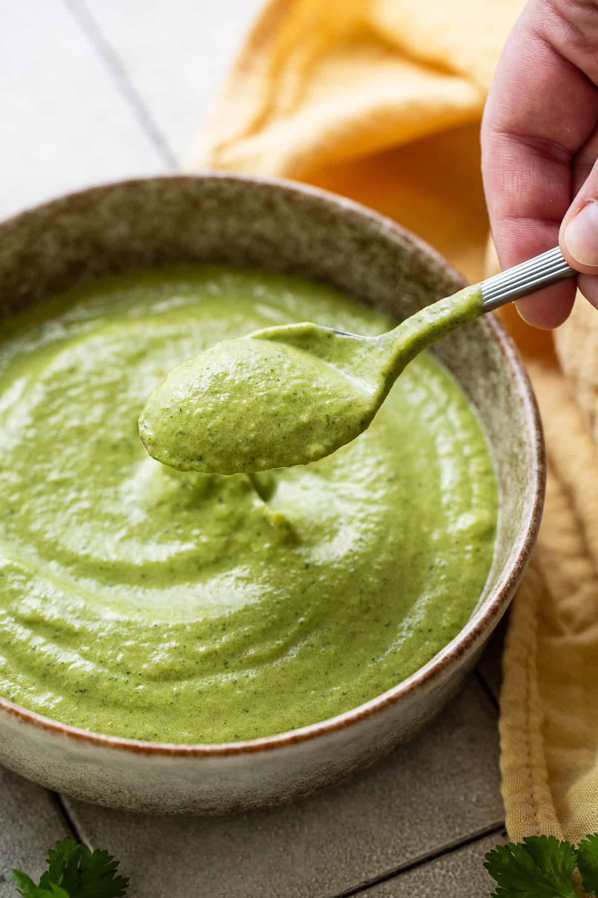 Creamy roasted poblano cream sauce in a small bowl ready to serve.