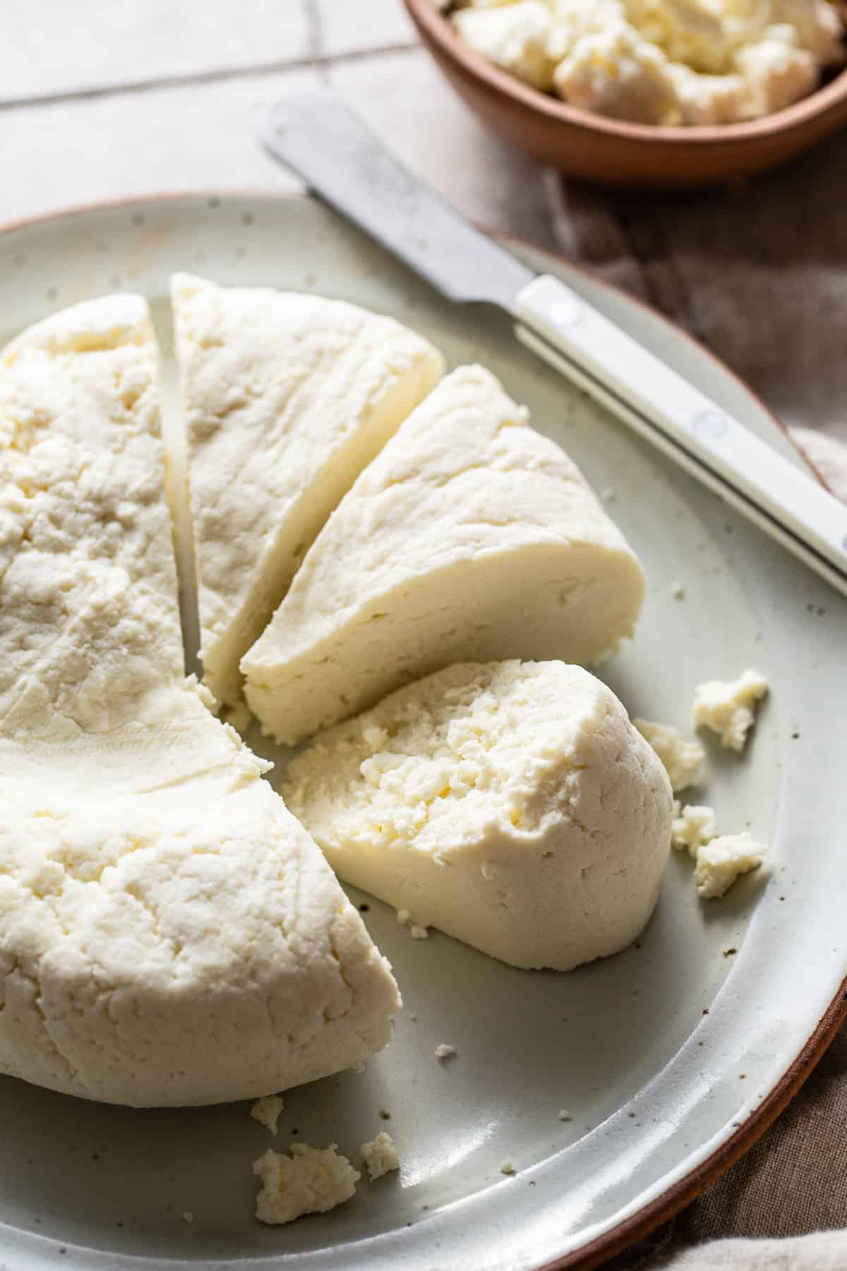 Fresh queso fresco cut into triangle shapes and ready to eat.