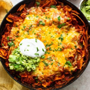 Chicken enchilada skillet topped with sour cream and ready to serve.