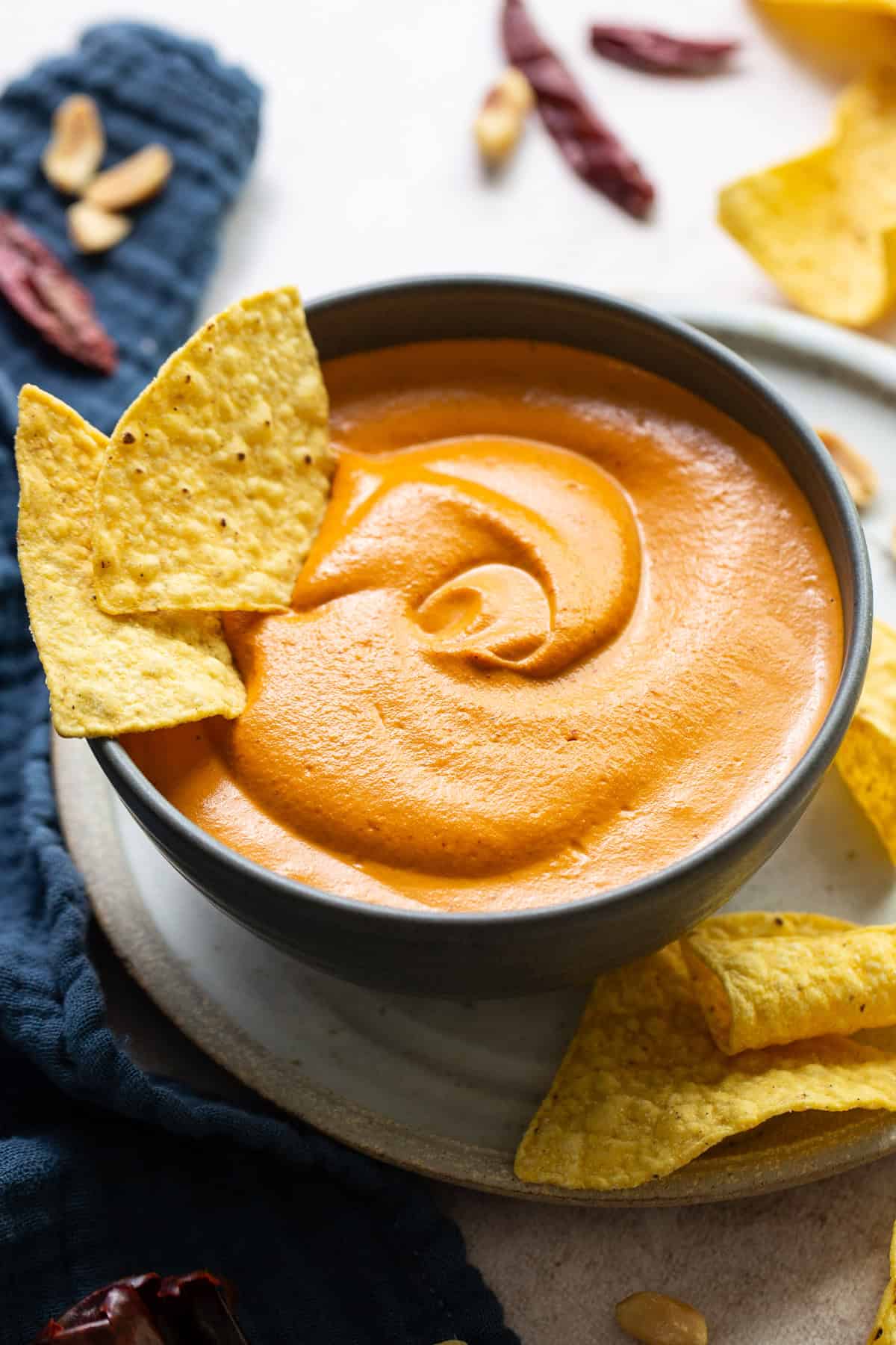 Blended salsa de cacahuate in a bowl served with tortilla chips.