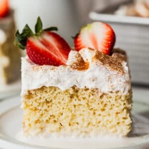 A slice of tres leches cake on a plate.