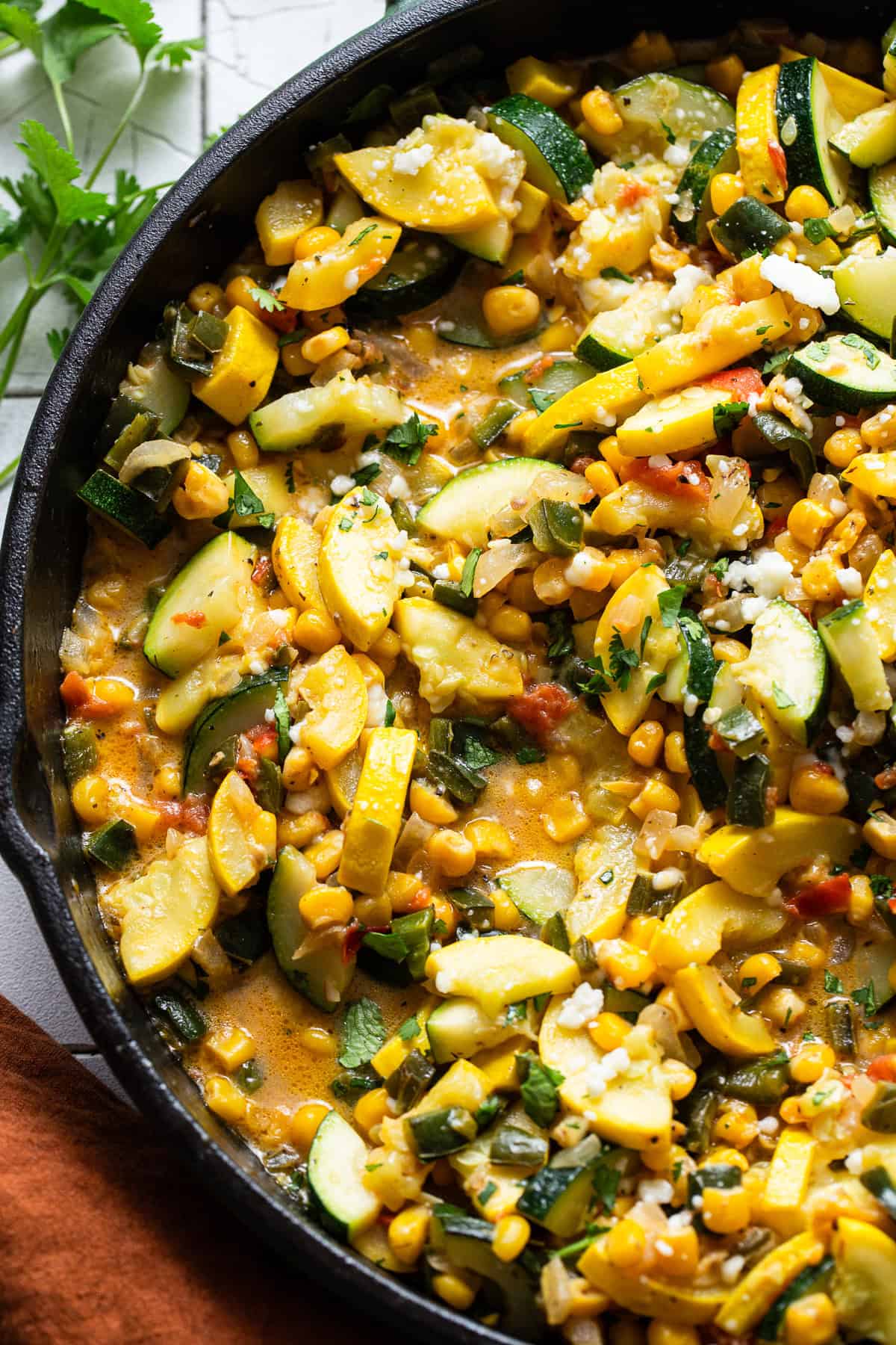 The best calabacitas recipe in a skillet with a light cheese sauce.