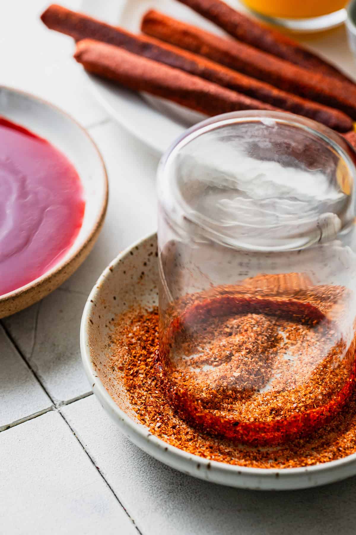 Dip the glasses rim in some chamoy, then fill a bowl with chili lime seasoning, and coat the edges of the cup.