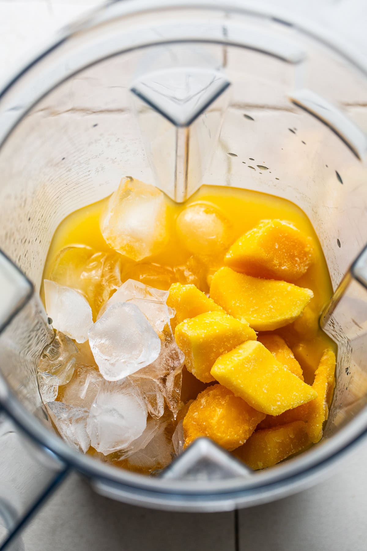 A blender filled with all of the mangonada ingredients. 