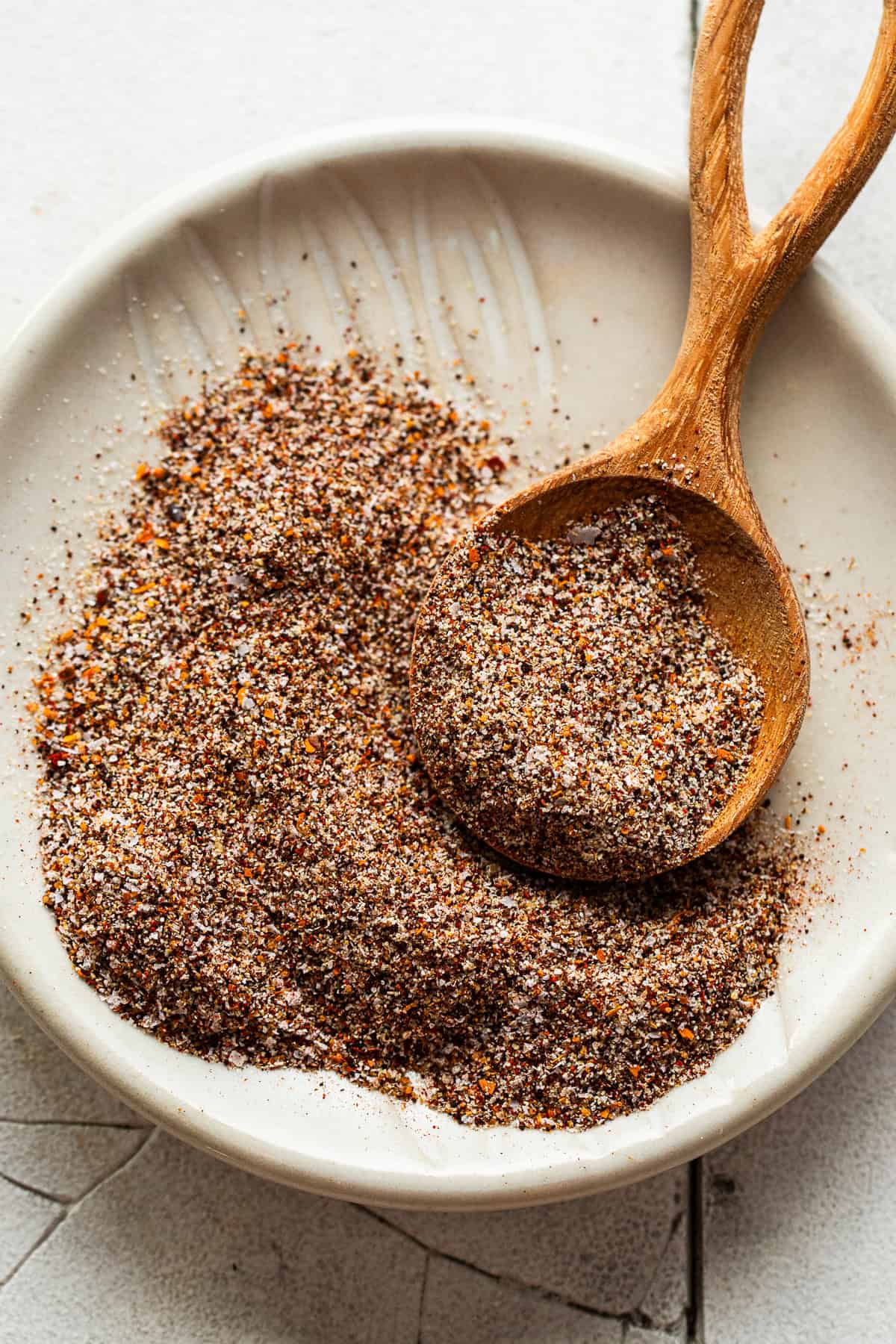 Fajita seasoning recipe blend in a bowl with a measuring spoon.
