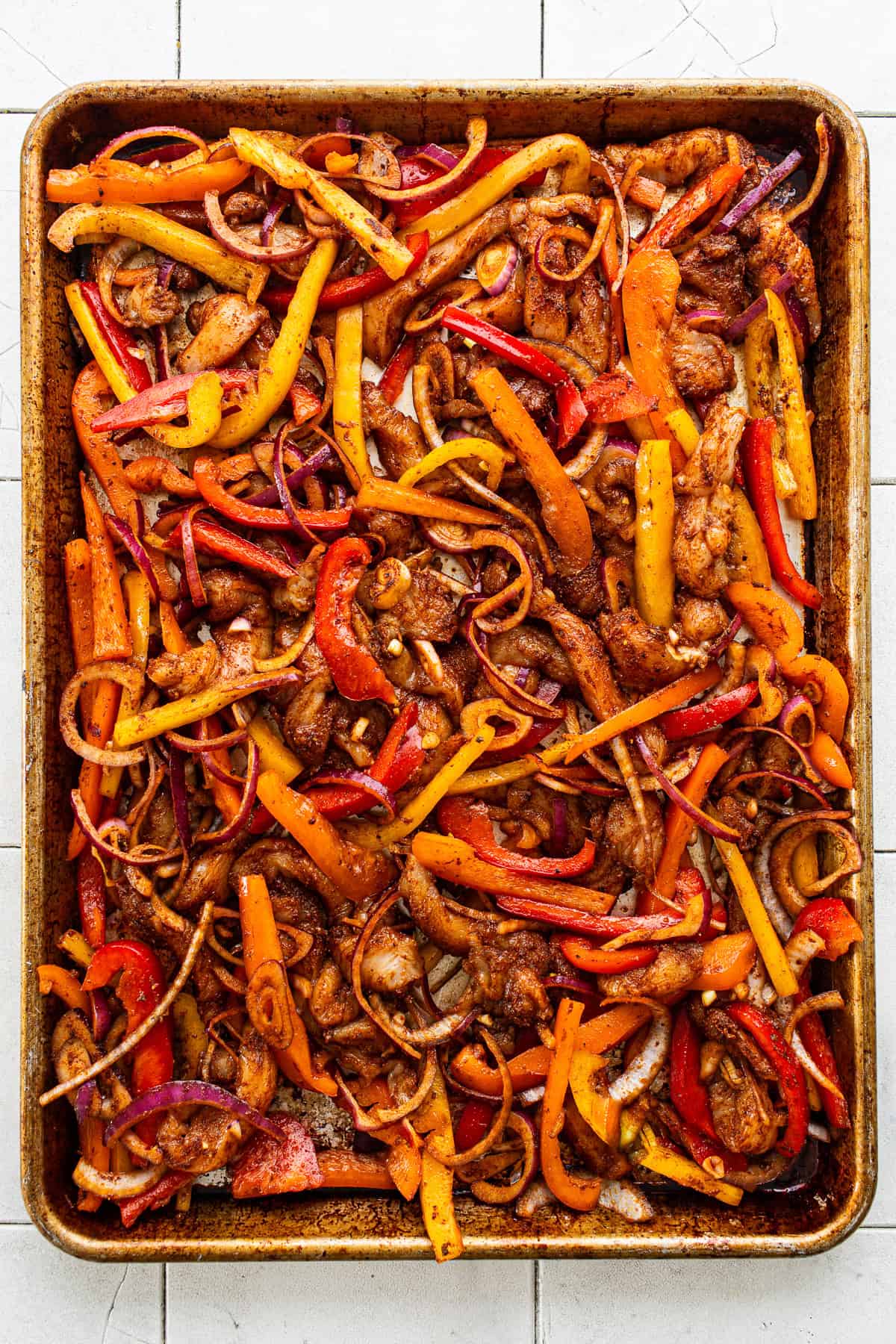 Sheet pan chicken fajitas before being baked.