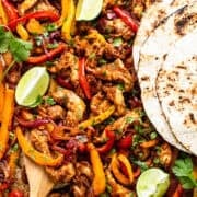 Sheet pan chicken fajitas with tortillas ready to eat.