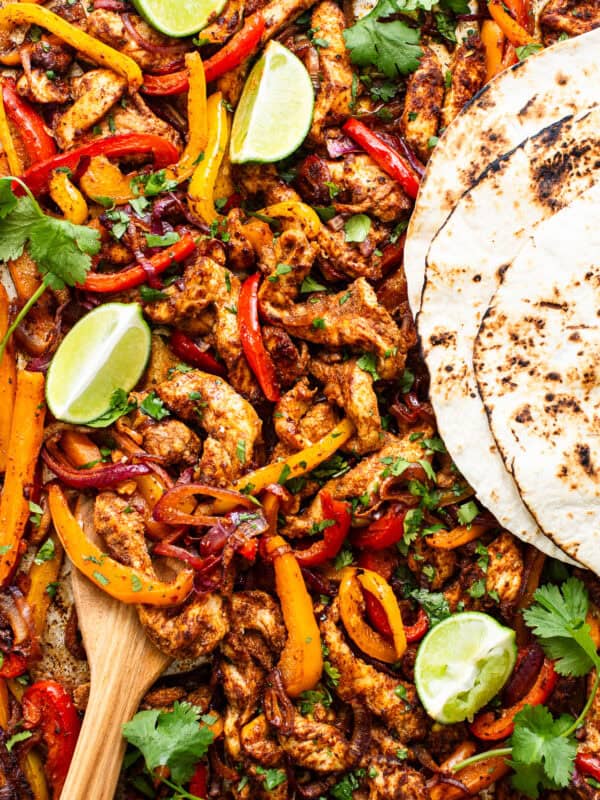 Sheet pan chicken fajitas with tortillas ready to eat.