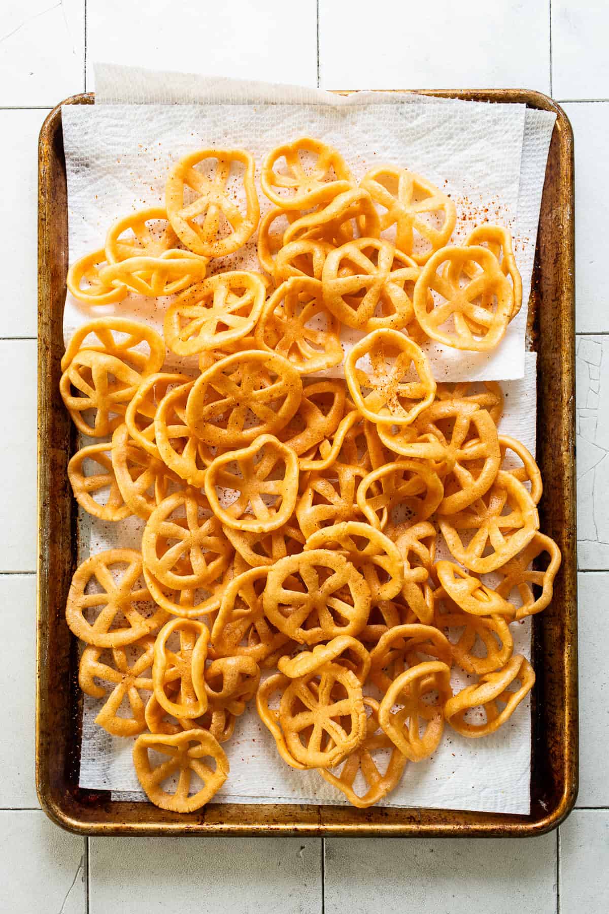 Chicharrones de harina draining on a sheet pan.
