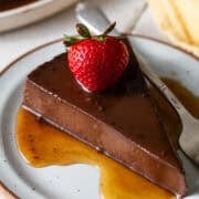A slice of chocolate flan on a plate.