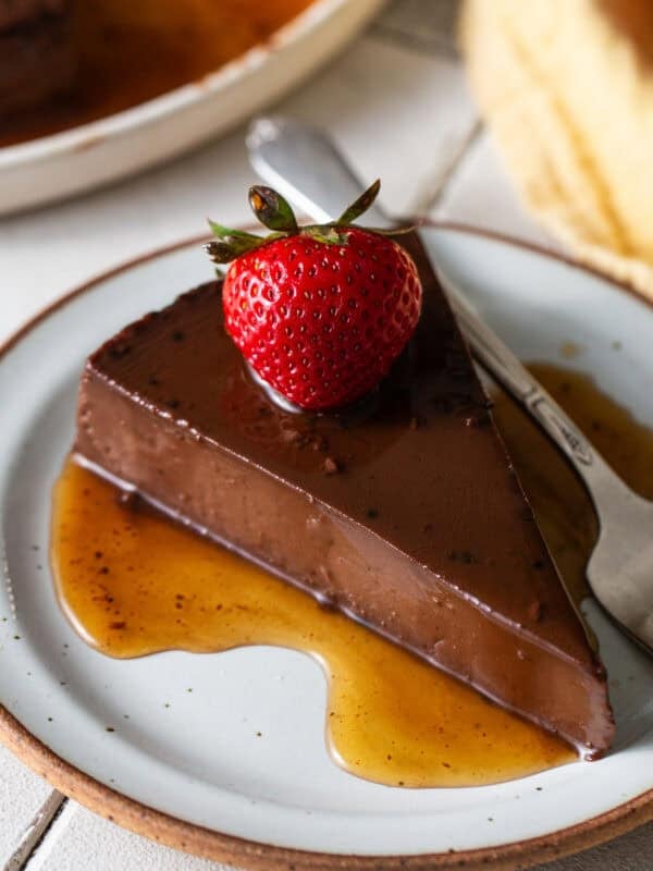 A slice of chocolate flan on a plate.