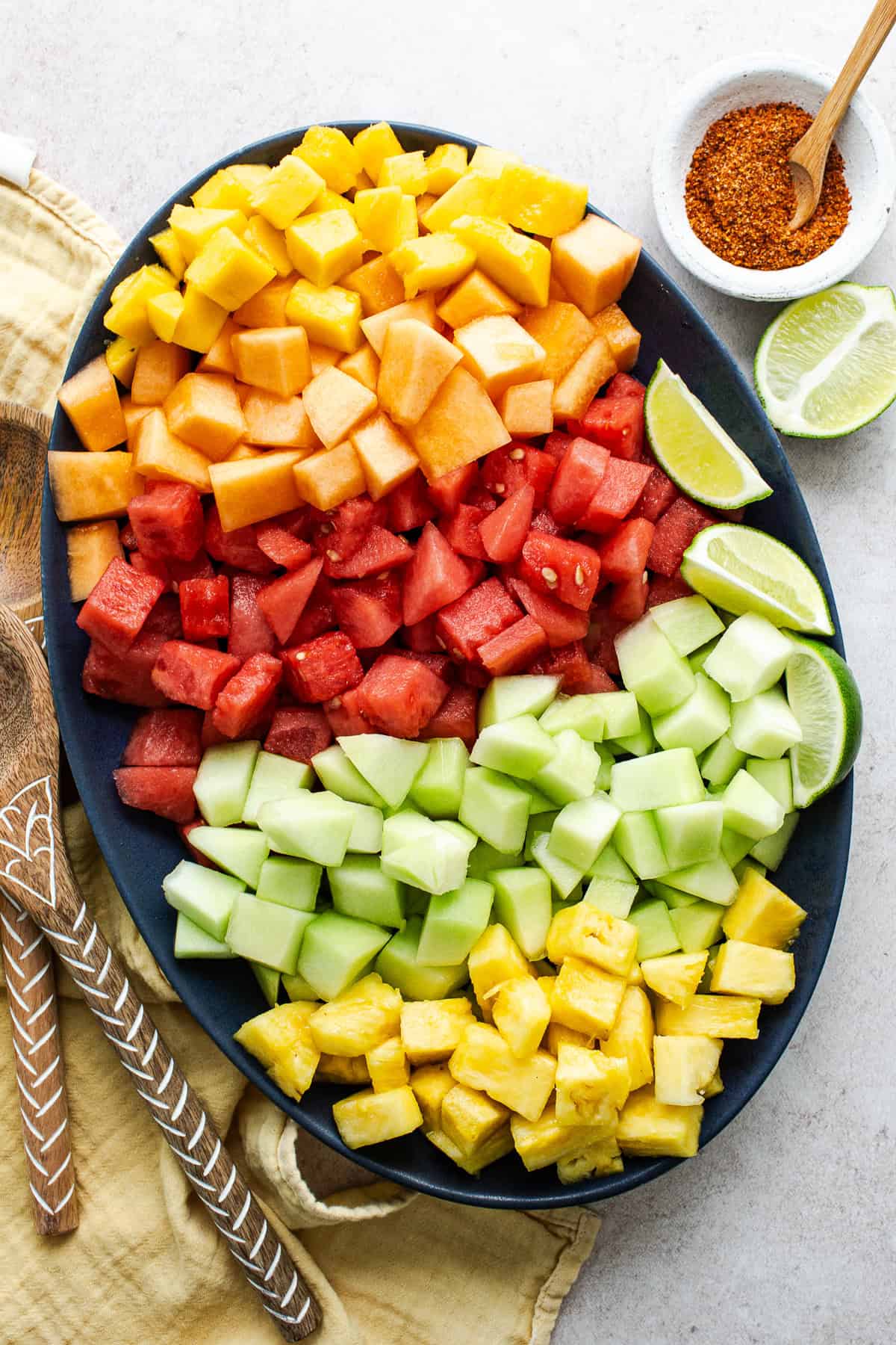 Diced mango, cantaloupe, watermelon, honeydew, and pineapple in a bowl.