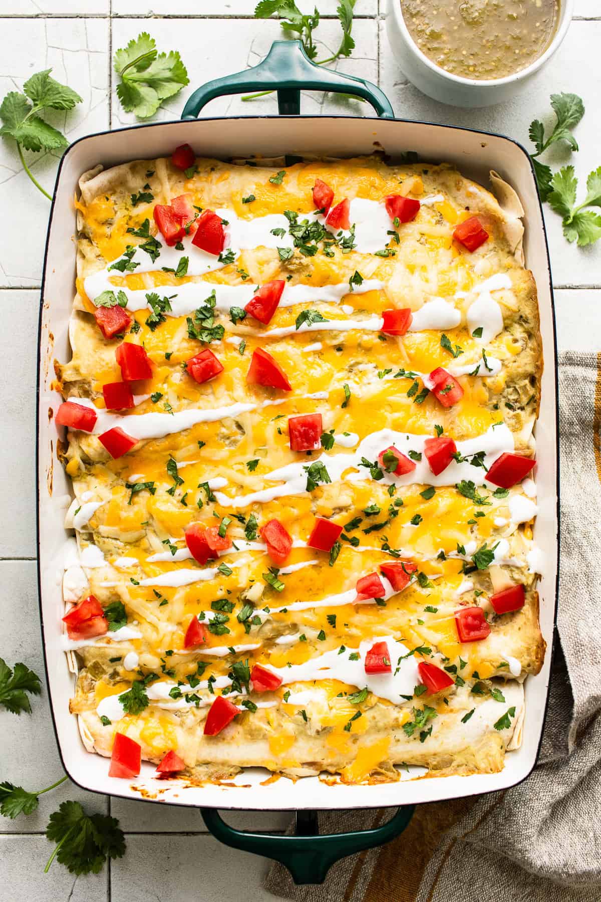 Cream cheese chicken enchiladas in a baking dish.