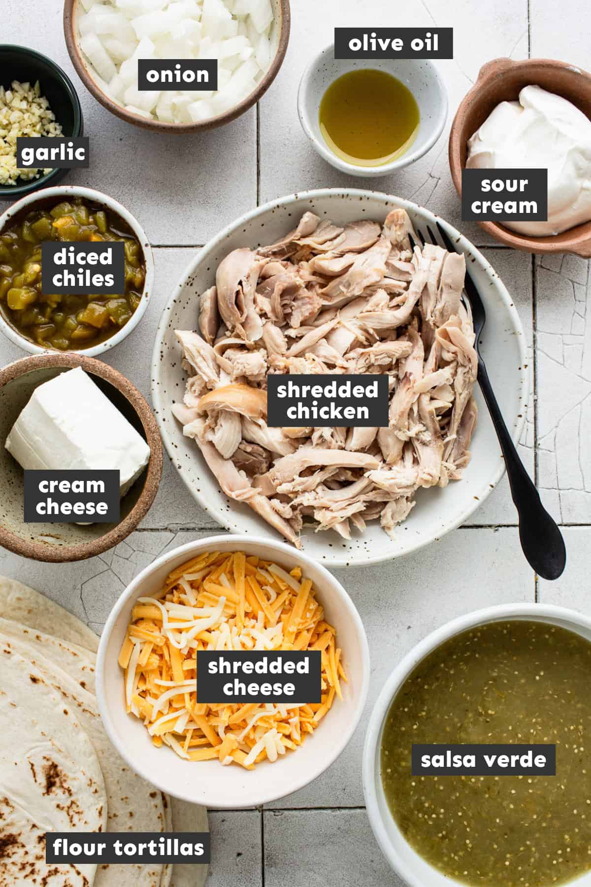 Ingredients in cream cheese chicken enchiladas on a table.