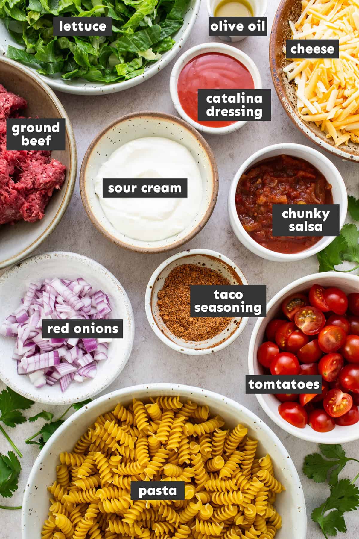 Ingredients for taco pasta salad on a table.