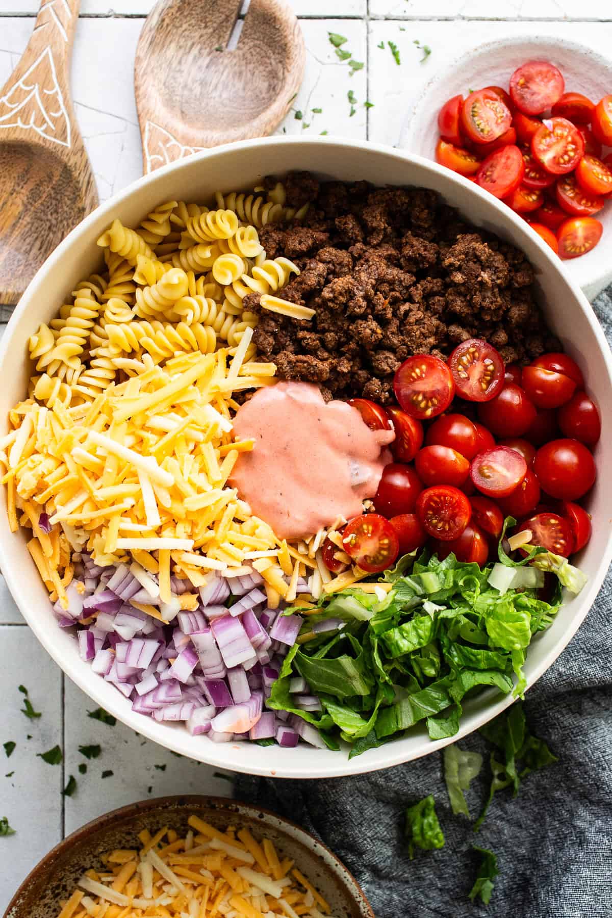 All the ingredients for taco pasta salad in a bowl before being mixed together.