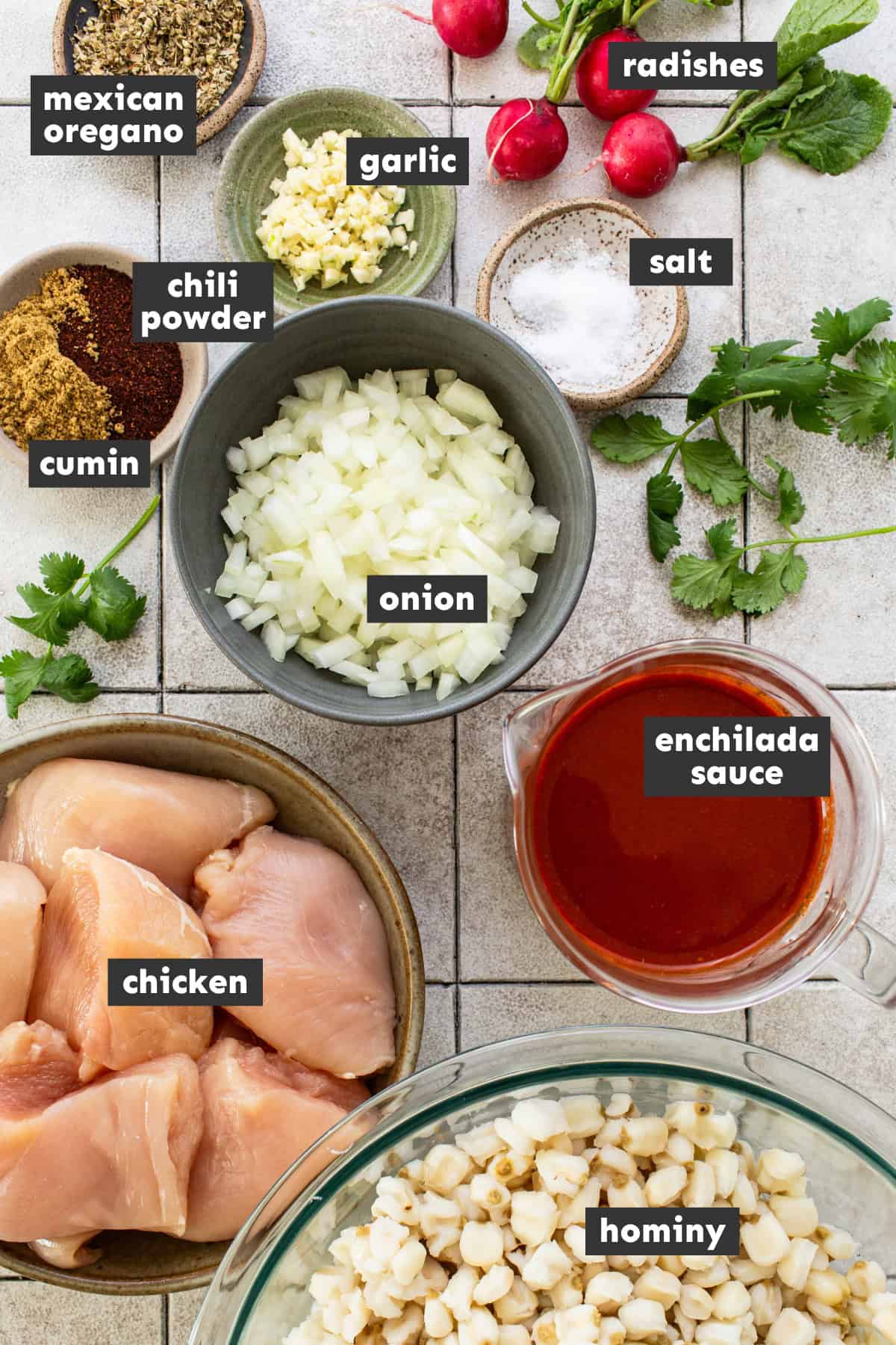 Ingredients for chicken pozole on a table.