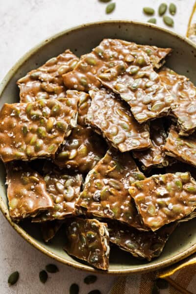 Pieces of pumpkin seed brittle in a bowl ready to serve.