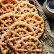 Crispy pumpkin buñuelos de viento covered with cinnamon sugar.
