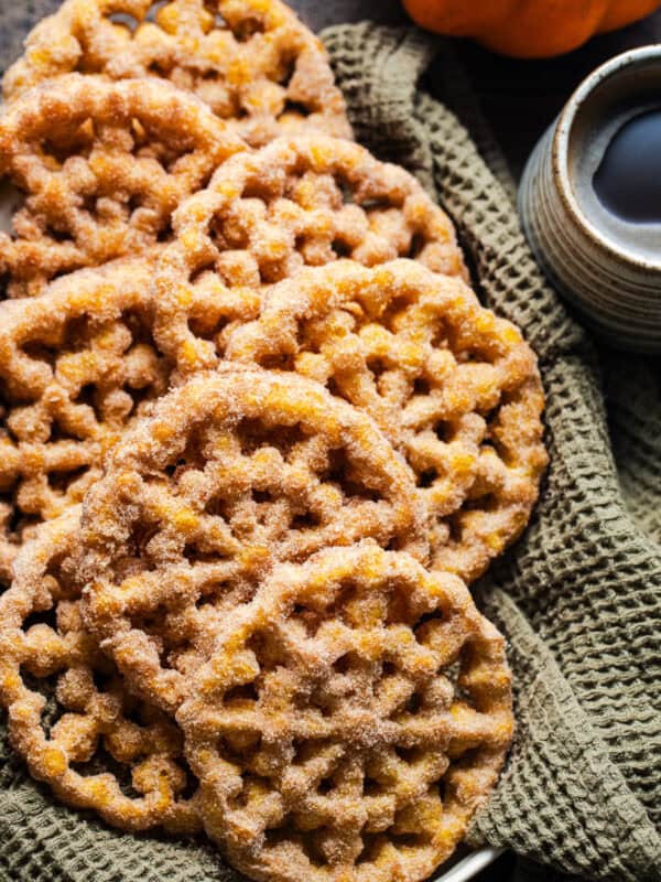 Crispy pumpkin buñuelos de viento covered with cinnamon sugar.