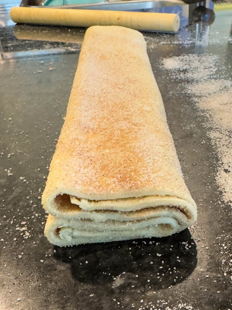 Folded puff pastry dough for orejas before being sliced.