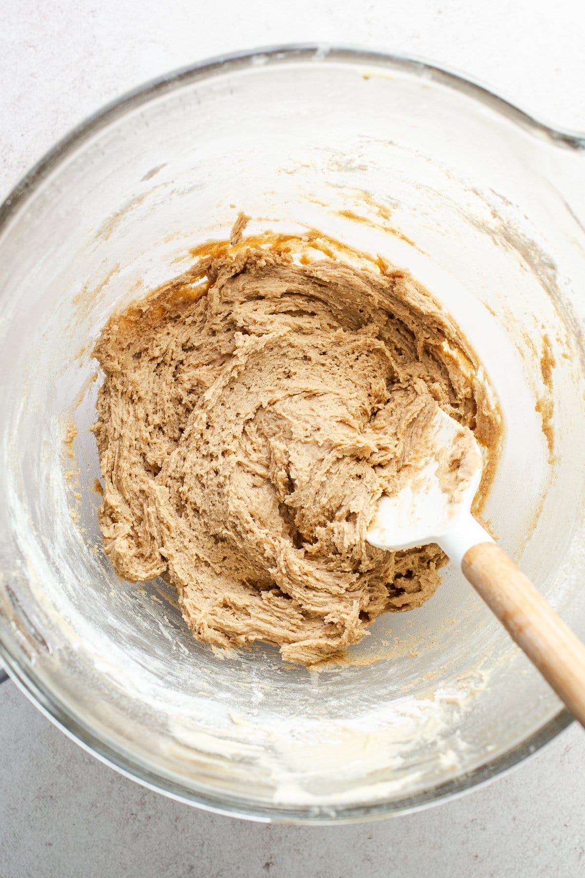 Churro cookie batter in the bowl of a stand mixer.