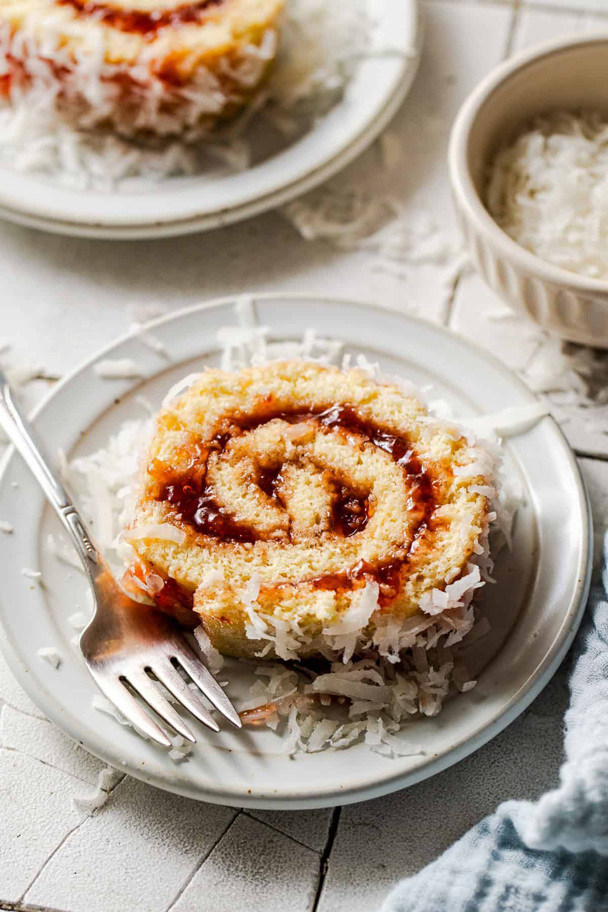 A slice of niño envuelto on a plate with a fork.