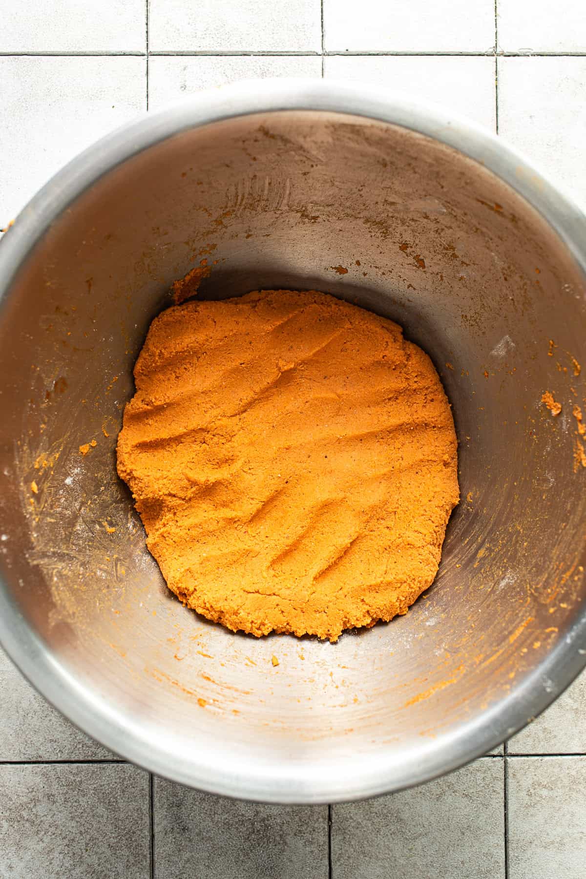 The chile-infused masa for enchiladas potosinas in a bowl ready to be pressed.
